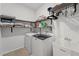Laundry room with washer, dryer, utility sink, and shelves for storage at 438 Southland Cir, Canton, GA 30115