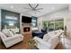 Bright living room with a stone fireplace, modern decor, and a sliding glass door to the patio at 438 Southland Cir, Canton, GA 30115