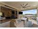 Covered patio with comfortable seating, outdoor television, and a view of the neighborhood at 438 Southland Cir, Canton, GA 30115