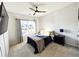 Bedroom featuring neutral carpeting, ceiling fan, and large window at 7860 Bristol Valley Dr, Cumming, GA 30028