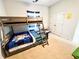 Cozy bedroom featuring a wooden bunk bed with blue bedding and striped curtains at 7860 Bristol Valley Dr, Cumming, GA 30028