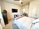 Comfortable bedroom featuring a bed, a TV, and carpet, with a view of the hallway at 7860 Bristol Valley Dr, Cumming, GA 30028