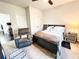 Cozy bedroom with a chair, a bed, and a carpet, with a view of the hallway at 7860 Bristol Valley Dr, Cumming, GA 30028