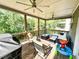 Relaxing covered deck with ceiling fans and wooded views, perfect for outdoor living at 7860 Bristol Valley Dr, Cumming, GA 30028