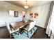 Bright dining room with a wood table, decorative wainscoting, and wood floors at 7860 Bristol Valley Dr, Cumming, GA 30028