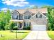 Charming two-story brick home with a well-manicured lawn and attached two car garage at 7860 Bristol Valley Dr, Cumming, GA 30028