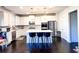 Bright kitchen with white cabinets, stainless steel appliances, and a center island with bar stool seating at 7860 Bristol Valley Dr, Cumming, GA 30028