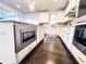 Modern kitchen featuring white cabinets, stainless steel appliances, an island, and hardwood flooring at 7860 Bristol Valley Dr, Cumming, GA 30028