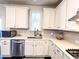Kitchen with white cabinets, stainless steel appliances, a sink, and subway tile backsplash at 7860 Bristol Valley Dr, Cumming, GA 30028