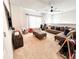 Bright upstairs living room with plush carpeting, a ceiling fan, and a large sectional sofa at 7860 Bristol Valley Dr, Cumming, GA 30028