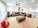 Upstairs living room with plush carpeting, a ceiling fan, and a large sectional sofa at 7860 Bristol Valley Dr, Cumming, GA 30028