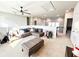 Upstairs living room with plush carpeting, a ceiling fan, and a sectional sofa at 7860 Bristol Valley Dr, Cumming, GA 30028