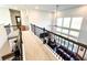 Upstairs loft boasting natural light, with views of the living room below at 7860 Bristol Valley Dr, Cumming, GA 30028