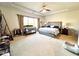 Spacious main bedroom featuring a ceiling fan and a large window for natural light at 7860 Bristol Valley Dr, Cumming, GA 30028
