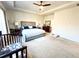 Spacious main bedroom featuring a ceiling fan and a large window for natural light at 7860 Bristol Valley Dr, Cumming, GA 30028