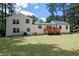 Spacious backyard with lush green grass, complemented by the home's exterior and surrounding trees at 1241 Bethsaida Rd, Riverdale, GA 30296