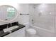 Modern bathroom with marble-style tile, a deep soaking tub, and a sleek vanity at 1241 Bethsaida Rd, Riverdale, GA 30296