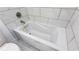 Close-up of a modern bathroom jacuzzi-style tub surrounded by marble-style tile at 1241 Bethsaida Rd, Riverdale, GA 30296
