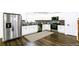 Well-lit kitchen featuring stainless steel appliances, white cabinetry, and a striking backsplash at 1241 Bethsaida Rd, Riverdale, GA 30296
