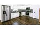 Bright modern kitchen with stainless steel appliances and white cabinetry and contrasting backsplash at 1241 Bethsaida Rd, Riverdale, GA 30296