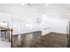 Bright, open living room featuring hardwood floors, access to stairs, and convenient connection to kitchen at 1241 Bethsaida Rd, Riverdale, GA 30296