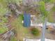 A top down view of the home, and long driveway on a grassy lot surrounded by lush trees at 26 Alisha Nw Cir, Cartersville, GA 30121
