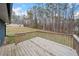 This is a spacious wooden deck with railings overlooking the grassy and wooded backyard at 26 Alisha Nw Cir, Cartersville, GA 30121