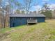 View of the home's backyard featuring a wooden deck, with a backdrop of mature trees at 26 Alisha Nw Cir, Cartersville, GA 30121