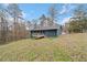 View of backyard featuring the blue exterior with a deck and a grassy, wooded area at 26 Alisha Nw Cir, Cartersville, GA 30121