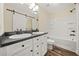 Bathroom with double sink vanity, granite countertop, barn door, and shower at 26 Alisha Nw Cir, Cartersville, GA 30121