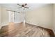Bedroom featuring wood-look floors, ceiling fan and barn door access to bathroom at 26 Alisha Nw Cir, Cartersville, GA 30121