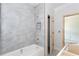 A view of a bathroom with a finished tile surround, tub and doorway leading to another room at 4222 Matisse Ln, Fairburn, GA 30213