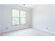 An unfinished bedroom with a large window for natural light at 4222 Matisse Ln, Fairburn, GA 30213