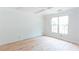 Unfinished bedroom showcasing a bright, airy space with hardwood floors and a large window at 4222 Matisse Ln, Fairburn, GA 30213