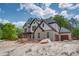 Newly built brick home featuring a three-car garage and modern design, surrounded by lush trees at 4222 Matisse Ln, Fairburn, GA 30213