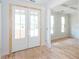 Elegant French doors leading to a bright, unfinished room with beautiful hardwood floors and coffered ceilings at 4222 Matisse Ln, Fairburn, GA 30213