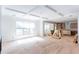 Bright open-concept living space with hardwood floors and coffered ceiling near kitchen awaiting final touches at 4222 Matisse Ln, Fairburn, GA 30213
