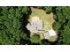 Aerial view of house with deck and stone patio surrounded by lush greenery at 116 Woolsey Creek Trl, Fayetteville, GA 30215