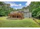 Back of house with deck, stairs, brick patio, garage and large yard at 116 Woolsey Creek Trl, Fayetteville, GA 30215