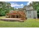Back of house with deck, stairs, brick patio, garage and large yard at 116 Woolsey Creek Trl, Fayetteville, GA 30215