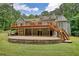 Back of house with deck, stairs, brick patio, garage and wooded area at 116 Woolsey Creek Trl, Fayetteville, GA 30215