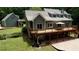 Expansive backyard featuring a large deck, patio, and lush greenery, ideal for outdoor living at 116 Woolsey Creek Trl, Fayetteville, GA 30215