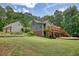 Expansive backyard with lush greenery, large wooden deck, and serene wooded backdrop, perfect for outdoor enjoyment at 116 Woolsey Creek Trl, Fayetteville, GA 30215