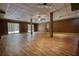 Finished basement with plank flooring, support columns and sliding glass doors at 116 Woolsey Creek Trl, Fayetteville, GA 30215