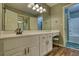 A bathroom features a sink with vanity, vanity lighting, and a tile shower-tub at 116 Woolsey Creek Trl, Fayetteville, GA 30215