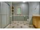 Updated bathroom with glass shower, tile floor, and wooden vanity, provides a clean and modern space at 116 Woolsey Creek Trl, Fayetteville, GA 30215