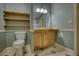 Stylish bathroom with wooden shelving, classic toilet, and tile flooring, offering a comfortable and refined feel at 116 Woolsey Creek Trl, Fayetteville, GA 30215