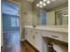 Bathroom featuring vanity, large mirror, vanity lighting, and view to the bedroom at 116 Woolsey Creek Trl, Fayetteville, GA 30215