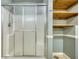 Bathroom showcasing a glass-enclosed shower and wooden shelving, creating a practical and pleasant space at 116 Woolsey Creek Trl, Fayetteville, GA 30215