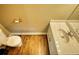 Compact bathroom with marble countertop vanity and a toilet with a wooden floor at 116 Woolsey Creek Trl, Fayetteville, GA 30215